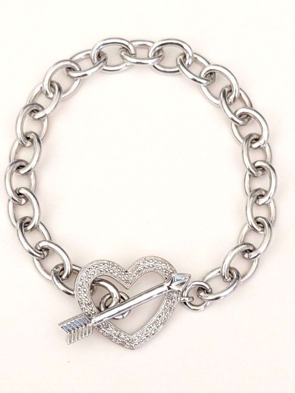 Silver textured heart with tiny faux diamonds and arrow toggle closure